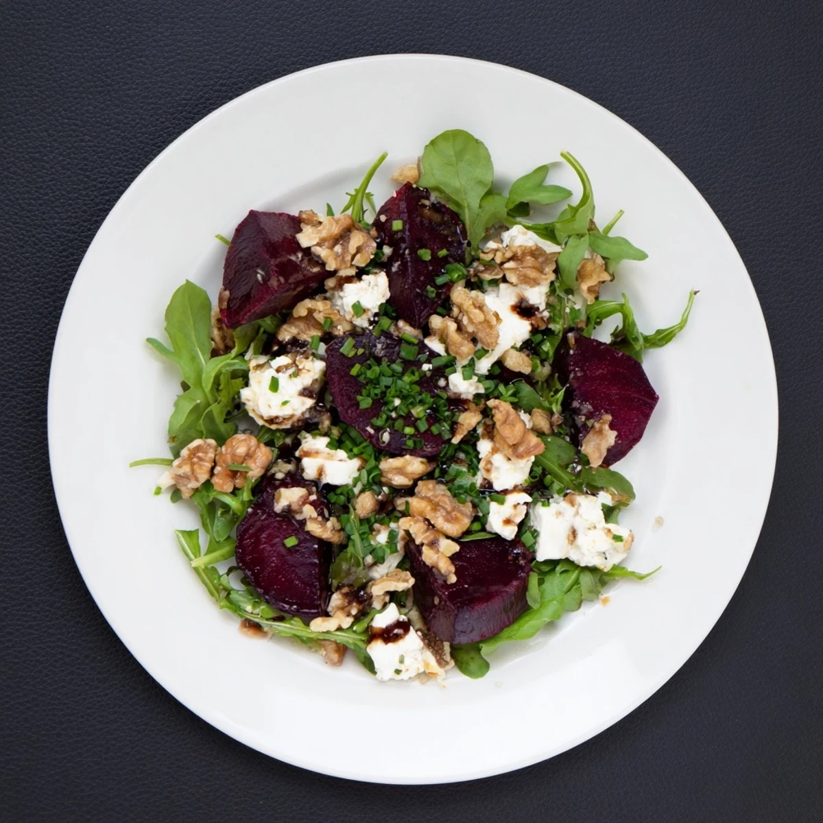 Dressed in a glossy balsamic vinaigrette, this Roasted Beet Goat Cheese Salad showcases ruby red beets, white goat cheese crumbles, and earthy walnuts, perfect for a healthy American lunch.