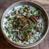 Wild Rice Mushroom Soup simmers in a rustic pot, releasing fragrant steam from thyme and rosemary over tender grains.