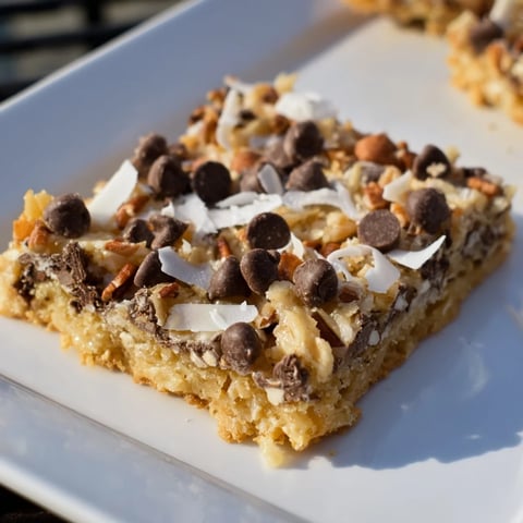 Magic Cookie Bars layered with chocolate chips, coconut, and pecans, a dessert to enjoy!