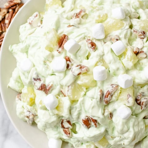 Creamy Watergate Salad, a chilled dessert with green pistachio pudding, marshmallows, and pecans.