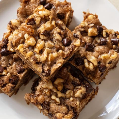 Warm, gooey blondies with melted chocolate, served fresh from the oven, a sweet treat.