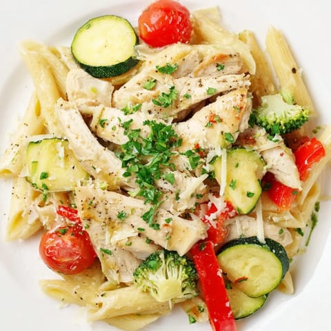 Roasted garlic herb chicken and colorful vegetables are tossed with penne pasta in a light, aromatic sauce for a hearty main dish.