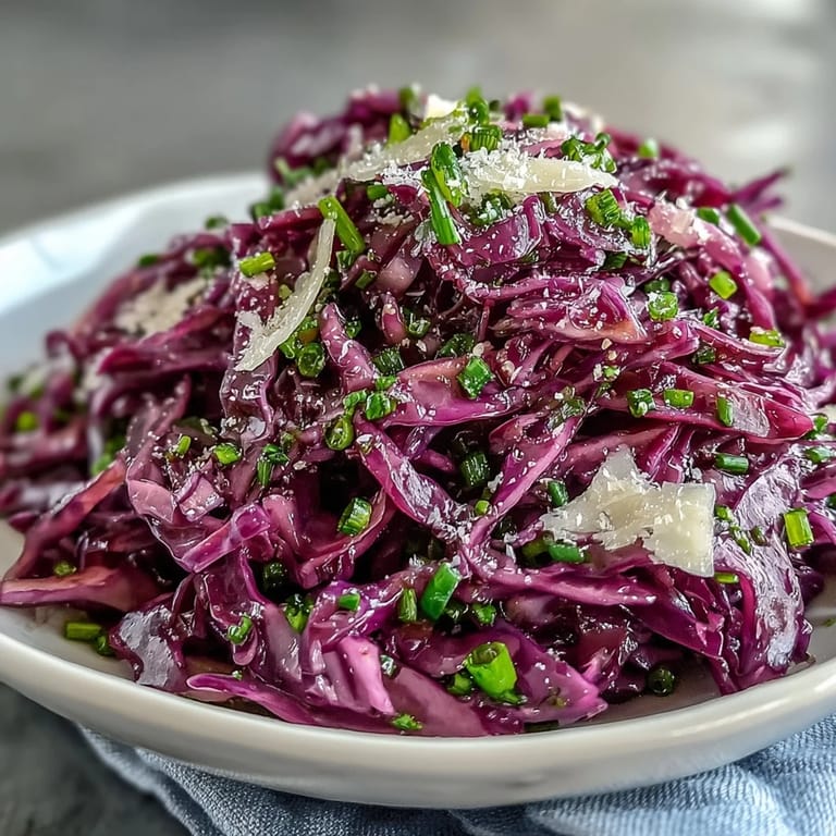 Healthy Red Cabbage Coleslaw with Apple and Parmesan, garnished with fresh parsley on a wooden serving platter.